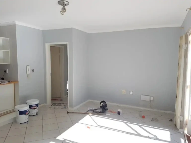 Room being painted with paint buckets on the floor during renovations